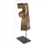 <p>Carranca navegada de Leão, escultura em bloco único de madeira com traços primitivos e expressivos, entalhada, patinada e com resqueícios de policromia, montada sobre base de ferro. (total c/ base). Brasil, início séc. XX</p>