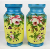 Par de vasos em opalina, nas cores azul e amarelo, decorada com pintura floral em policromia. Alt. 28 cm.