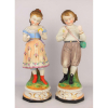 Belo par de esculturas em biscuit europeu, policromadas, representando Casal de crianças. Bases em porcelana. Alt. 34cm.