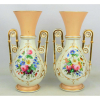 Par de vasos em porcelana francesa, Velho Paris, policromada, decorado com pintura floral em reserva. Detalhes em dourado e alças vazadas. Alt. 25cm.