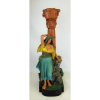 Antiga escultura em terracota policromada, representando Figura Egípcia, recortada em uma coluna com chaminé, sendo esta decorada com rostos. Apresenta perda na lateral de um dedo do pé. Al. 54,5cm. 