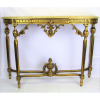 Aparador estilo francês Luis XVI, em madeira dourado e entalhada. Pernas se unindo por 2 travessões a um bilro central. Tampo com mármore. Minúscula perda no pé. Med. 81x112,5x31 cm.