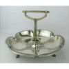 Elegante petisqueira art-deco, em prata alemã, contrastada, trabalhada com delicados detalhes. Alças central com trabalhos de frisos. Pés com vazados. Marca do contraste, teor e prateiro. Med. 18x25 cm. Peso 325 g.