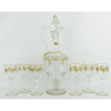 Baccarat - Elegante conjunto de licoreiro com alça e 6 taças em cristal francês. Peças com delicados trabalhos em ouro brunido e guirlandas em satiné. Licoreiro com lapidações dedão e facetadas. Taças com hastes sextavadas. Alt. licoreiro 38,5 cm.