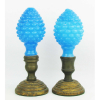 Duas antigas pinhas de coleção, do Séc. XIX, em opalinas francesas sopradas, no tom azul, decoradas com trabalhos em relevo. Base original em bronze sobre peanhas em madeira contemporâneas as peças. Alts. 22cm.