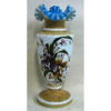 Belo vaso em opalina européia, soprada, na cor leitosa, com pintura esmaltada de flores e folhas em policromia. Borda em babados. Interior na cor azul. Alt. 42cm.