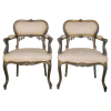 Par de cadeiras, estilo francês, Luis XV, em madeira dourada e entalhada. Encosto, assento e braçadeiras estofadas e forradas em tecido. (perdas no dourado). Med. 87x63x47cm.