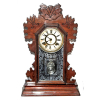 ANSONIA Clock Co. U.S.A. Modelo: Beaver, ca 1894.<br />57X39X12 cm.<br />De mesa ou parede. Caixa original em madeira de nogueira entalhada. Vidro original com gravação. Corda para 8 dias.<br />http://www.antiqueansoniaclocks.com/Ansonia-Model-0060.php