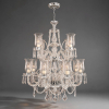 Lustre em cristal 24% de chumbo, estilo MARIE THERÉSE DE FRANÇA. Consta de 12 braços espiralados, três hastes espiraladas e torsas, pingentes em gota, donzelas lapidadas e acidadas, bobeches satinadas com cabochons e borda gomada. Manufatura nacional. Diâmetro: 72 cm. Altura: 115 cm.<br />*** Marie Therése foi a filha mais velha de Luís XVI e Maria Antonieta.<br />Ela se casou com seu primo, Louis Antoine, Duque de Angoulême, o filho mais velho do futuro Charles X. A linha Maria Thereza, criada no século XVIII, utilizada na iluminação dos castelos, igrejas e mansões da Europa, usando ainda a vela de parafina, foi inicialmente trazida, pela família real portuguesa que veio para o Brasil fugindo à invasão de Portugal por Napoleão Bonaparte. Desde a instalação do Império e durante a Monarquia do Brasil, passando pela Independência e Proclamação da República, os lustres Maria Thereza sempre foram utilizados especialmente pela nobreza e burguesia, até que no início do século XX, os comerciantes brasileiros passaram a trazer da Europa, mais precisamente da Bélgica e Tchecoslováquia, componentes que eram montados com peças produzidas no Brasil, principalmente no Rio de Janeiro e São Paulo.