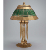 TIFFANY STUDIOS<br />Abajur de mesa, cúpula em metal dourado e pasta de vidro verde; base de bronze com douração. 37 cm de diâmetro, a cúpula; 55 cm de altura total. Marcas do fabricante na cúpula e na base. C. 1925.Cúpula reproduzida na página 191 e a base reproduzida na página 194 do livro Tiffany Lamps and Metalware, de Alastair Dancan.