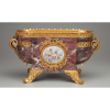 Centro de mesa de mármore brèche violette, bronze ormolu e reserva em ambos os ladoscom placas de porcelana de Sèvres. Estilo e época Napoleão III. 52 x 27 x 27 cm de altura. França, séc. XIX.