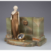 PREISS, Ferdinand - The Spring. Escultura de bronze e marfim, - base de ônix, apresenta relógio acoplado - em sua base. 31,5 x 19,5 x 28 cm de altura. - França, c. 1930.
