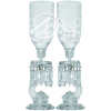 Par de castiçais de cristal moulé Baccarat; fuste no formato de delfim satinado, bobèche com longos pingentes facetados, base circular recortada, marcada Baccarat em relevo; mangas de cristal no formato de campânula invertida com bordo reto, decoradas com faixa de ramos e estrelas; 63 cm de altura total. França, séc. XIX. - Um deles apresenta discreto lascado assim como uma das mangas esta trincada.