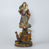 <p>Nossa Senhora da Penha - Bahia, Brasil, século XIX.Imagem de madeira policromada e dourada representando a Santa de pé sobre nuvem com cabeça de anjo e penhasco esculpido à maneira naturalista com devoto ajoelhado em prece, lagarto e carneiro. Cabelos encobertos por véu, braço direito flexionado e, o esquerdo, sustentando O Menino. Túnica e manto movimentados, azul, com partes douradas e vermelho encarnado; 40 cm de altura total.</p>