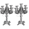 Par de candelabros de prata repuxada e cinzelada para cinco velas com quatro braços e suas bobeches com uma bobeche central; decoração com figurações fitomórficas; fuste torneado e segmentado sobre base quadrada com quatro pés de garras. Na lateral da base marca da prata SP do prateiro de Lorena, Claudio de Azevedo Ribeiro para o ano de 1835; 42 cm de altura. Brasil, séc. XIX. Pertenceu à Fazenda Ponte Alta em Campinas da família Teixeira de Camargo.Exemplar semelhante reproduzido à página 118 do livro Os Ourives na História de São Paulo, por Maria Helena Brancante.